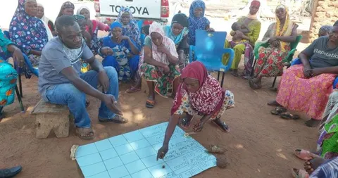 A facilitator meeting with community members